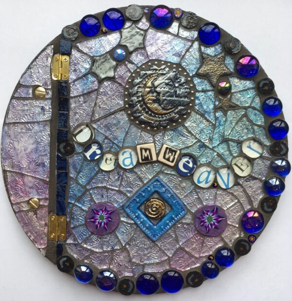 Image of a round mosaic book cover featuring glass, polymer clay pieces and found objects.