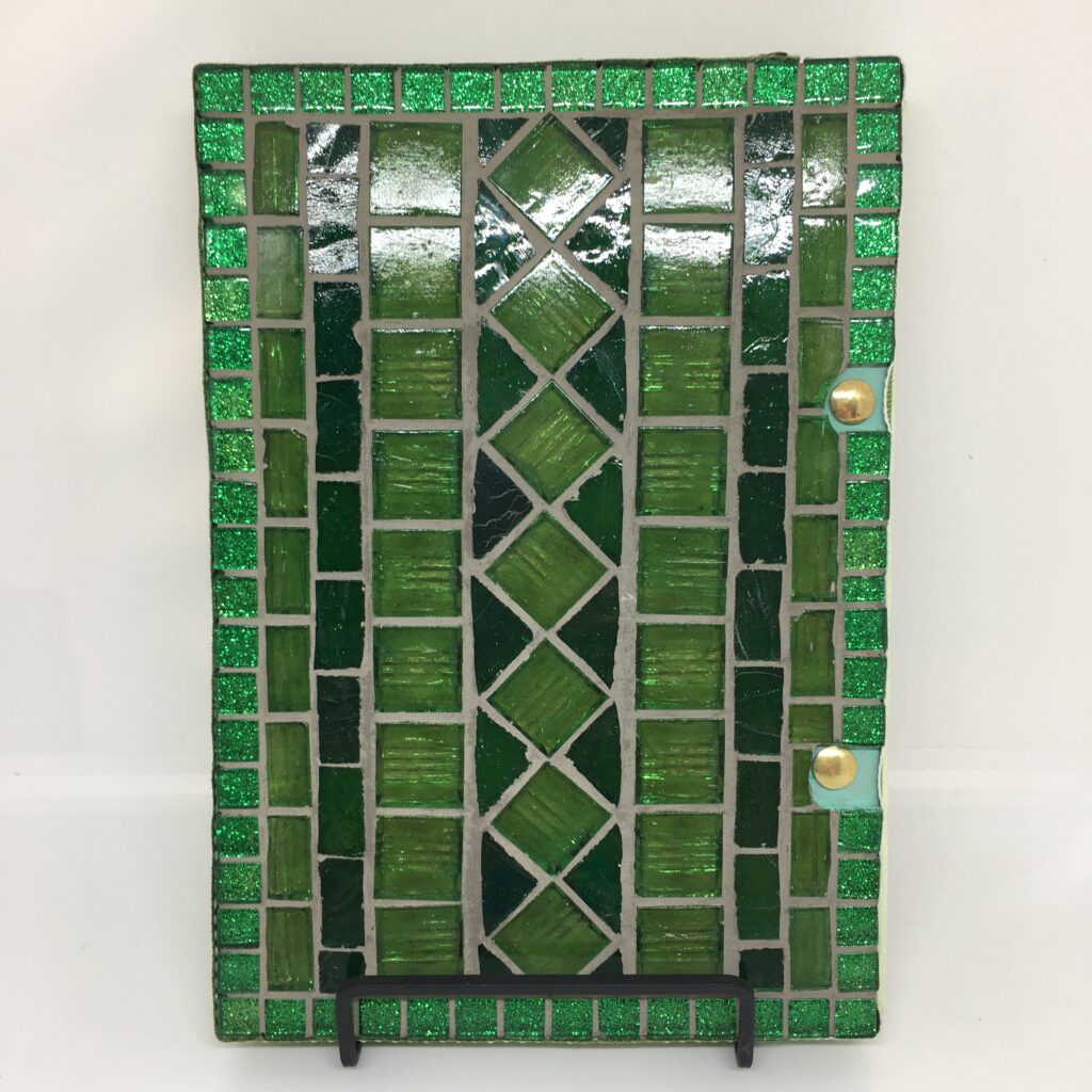 Back cover of Daffodil Days art journal featuring mosaic in green glass.